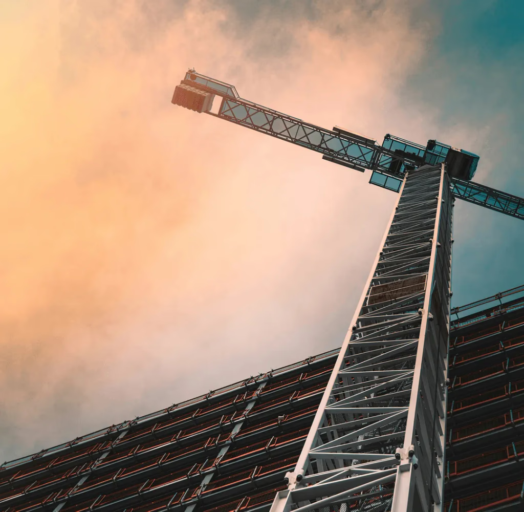 Tower crane rising above a building under construction